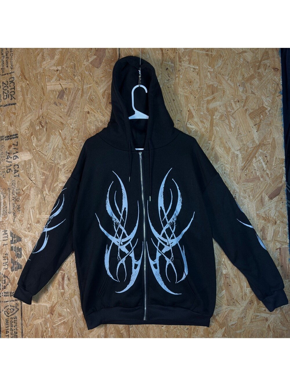 Black zip hoodie with white tribal graphics